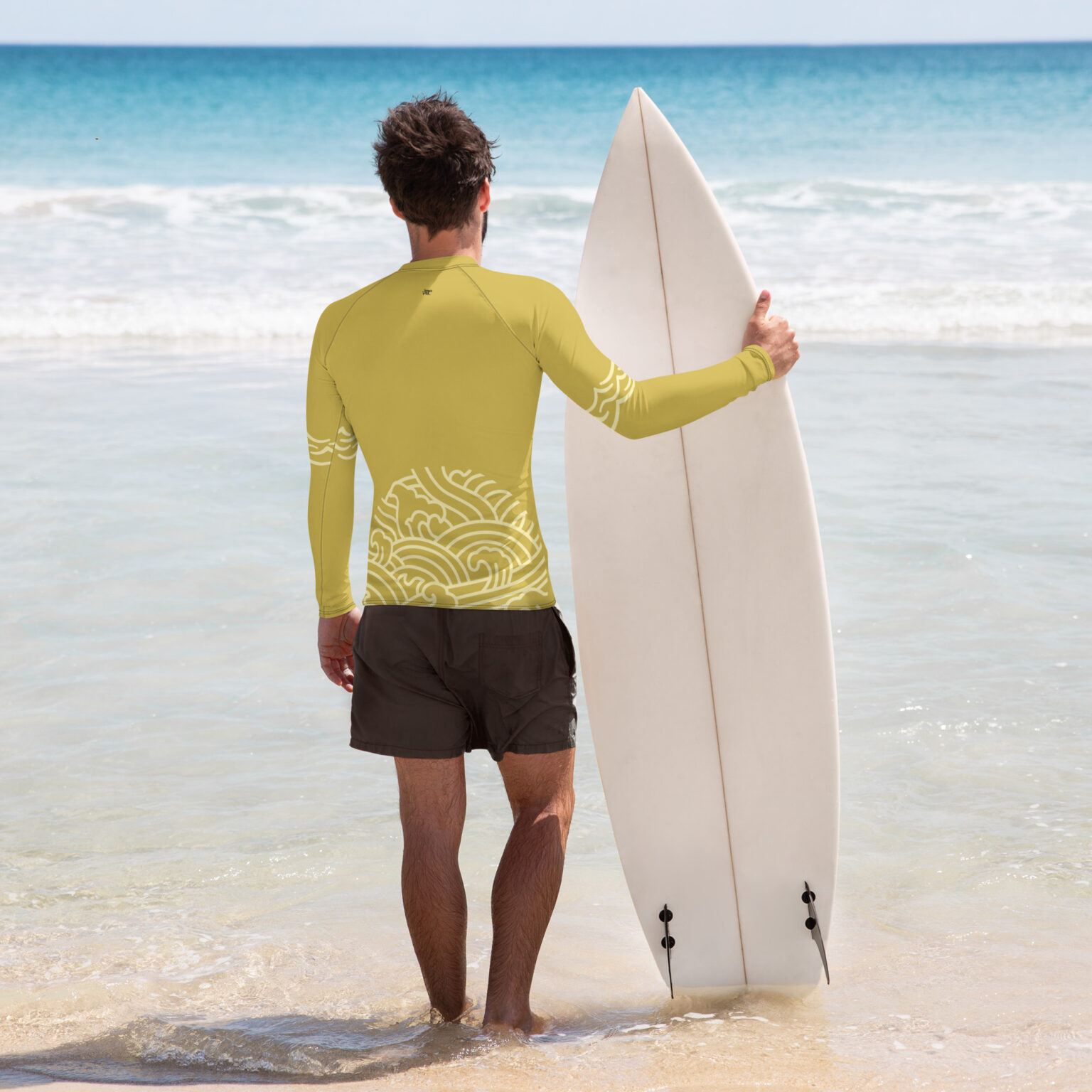 yellow rash guard old gold back of man on beach