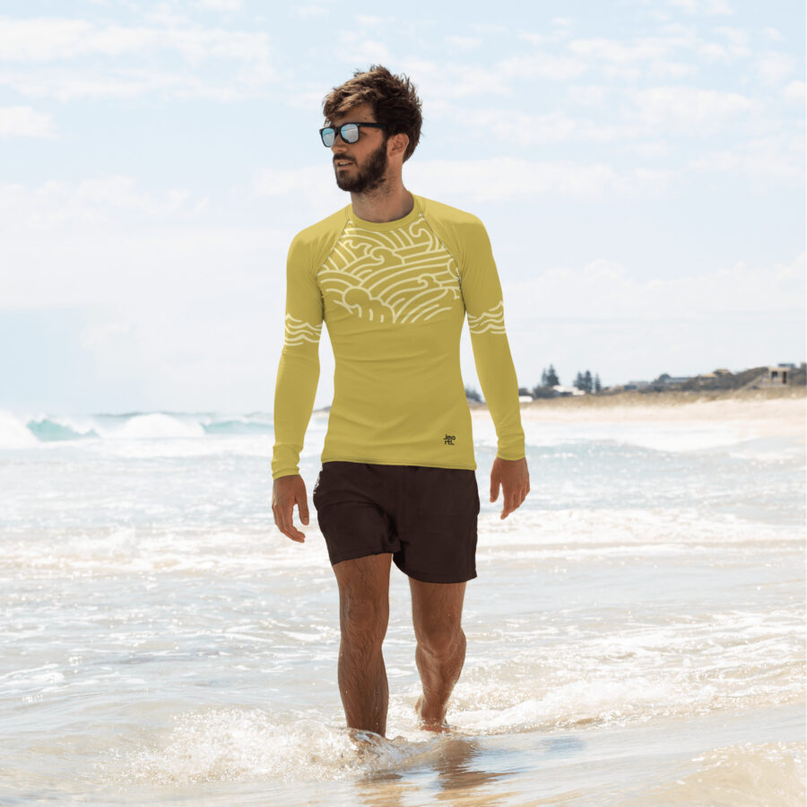 yellow rash guard old gold front of man on beach